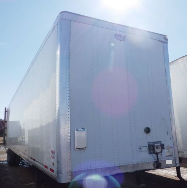 Rear and left side of a white 2014 Wabash dry van trailer showing smooth metal panels, rear doors, and standard equipment fittings.