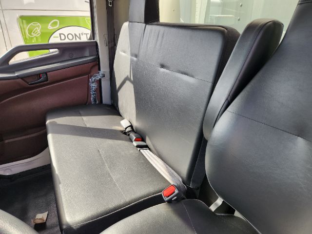 Cab and chassis interior showing black cloth seats with three-seat bench and seat belts in a new 2025 Hino L6 truck.