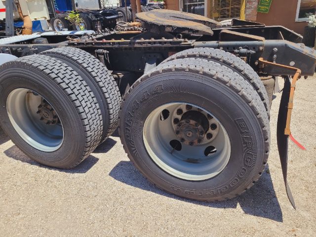 Volvo VNR daycab chassis showing dual rear axles with tires and rims.