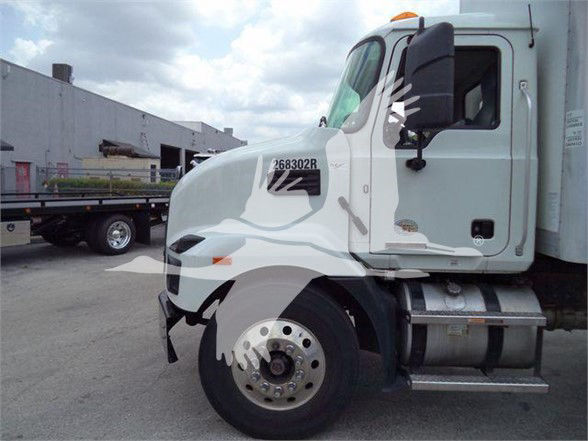 Truck cab side view showing Mack MD7 with VIN tag 1M2MDBAB3PS071396 and stock number 268302R on door.