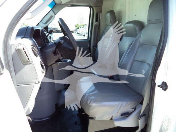 Ford E-Series van interior showing front seats and dashboard. Text not clearly visible.