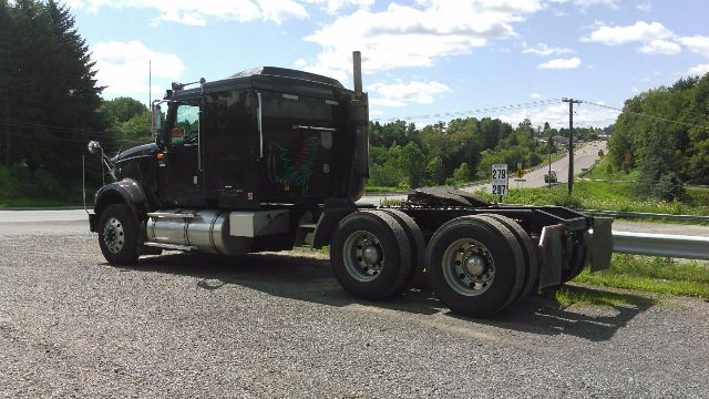 2007 International 9900i conventional sleeper truck chassis with dual rear axles on gravel.