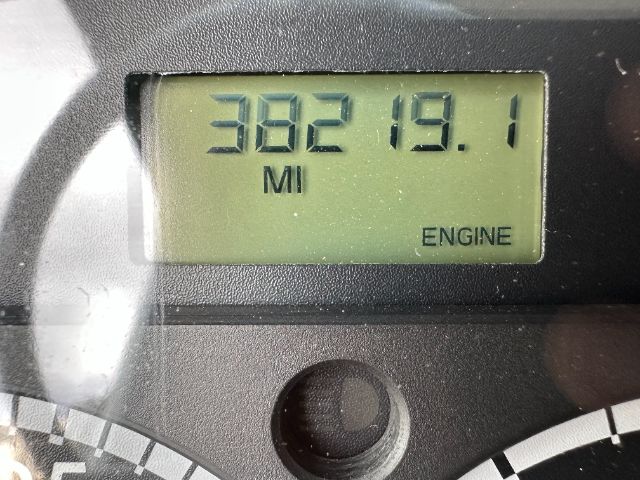 Dashboard display showing 382 miles and 19.1 miles to empty with 'ENGINE' label on a Freightliner truck gauge.