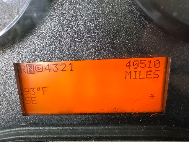 Dashboard display showing 'R N0 4 521' '40510 MILES' and temperature readouts '95°F' 'GE' on an orange LCD screen.
