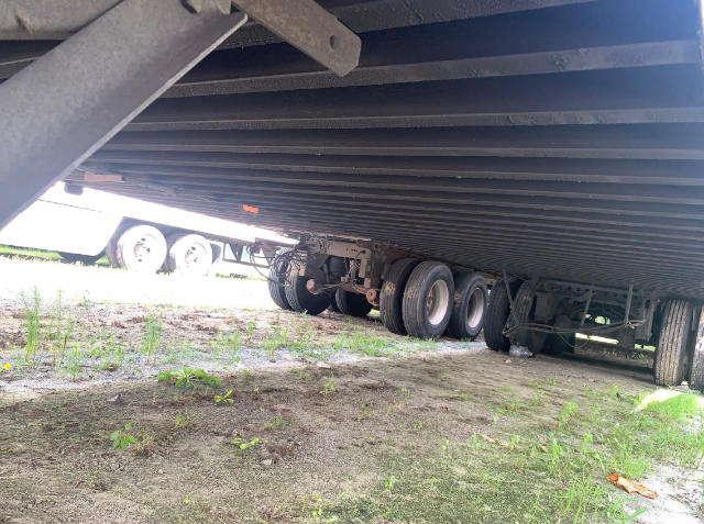 Underneath view of a Vanguard VXP trailer showing multiple axles and suspension with tires. No obvious labels visible.