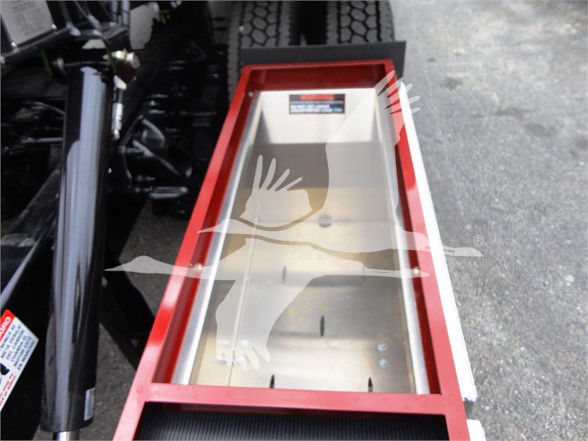 Peterbilt 337 truck step/ladder area showing a red-framed compartment with a reflective metallic interior and a warning sticker.