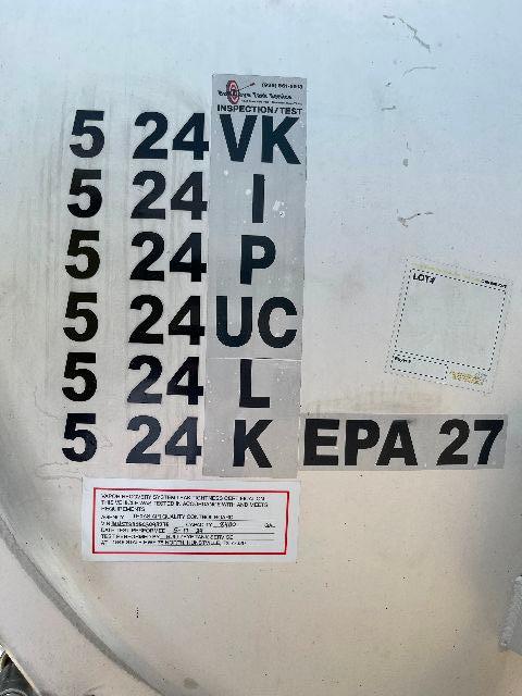 Crude oil tank trailer metal surface with vertical black numbers 5 24 VK 5 24 I 5 24 P 5 24 UC 5 24 L 5 24 K; EPA 27; small sticker details and red-bordered label.