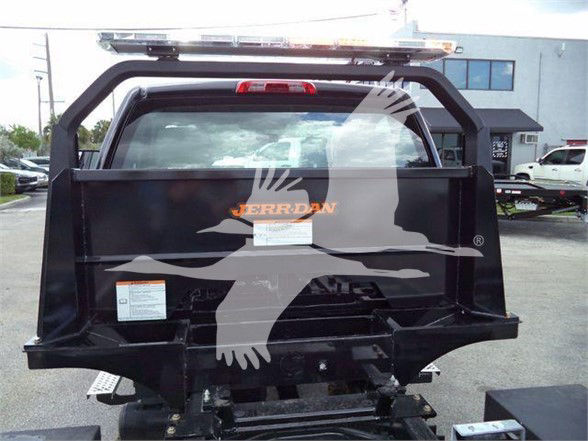 Truck bed or trailer hitch area of a 2023 Chevrolet Silverado 6500HD with black metal rear cargo area and safety light bar on top.