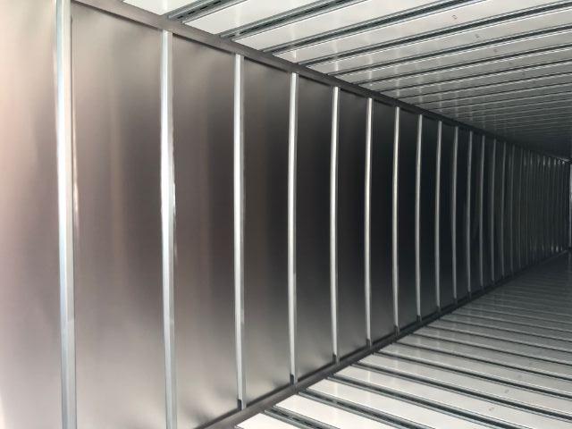 Inside the trailer showing metal ceiling and ribbed side walls.