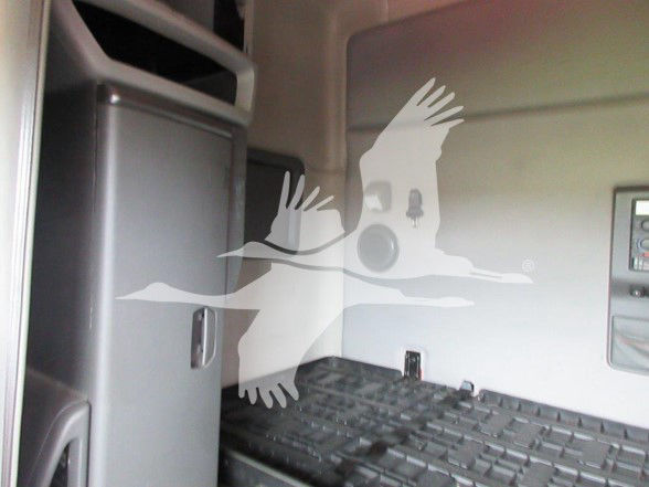 Interior of a Volvo truck cabin showing a raised bed area with a textured surface; faint silhouettes overlay from a watermark are present.
