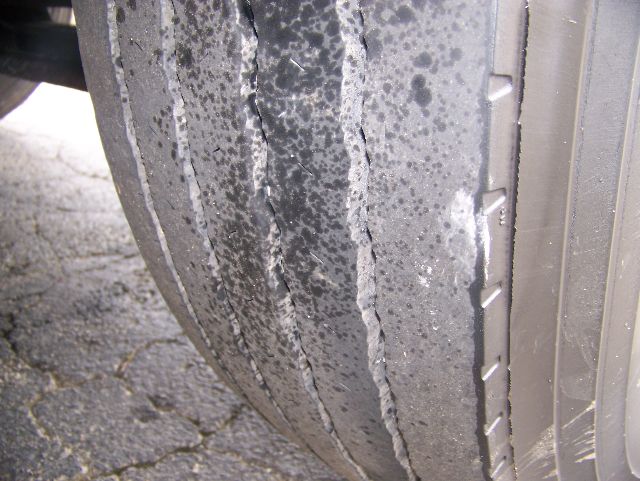 Tire tread and sidewall of a 2006 Peterbilt 335 truck showing worn tread and slick center.