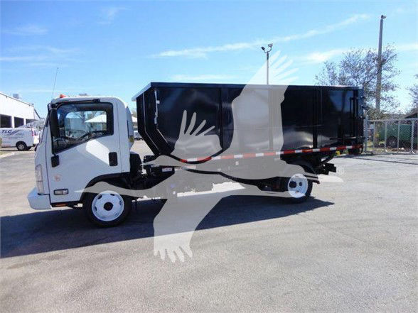 Isuzu NRR refuse truck in a used condition with a black dump body and white cab, side view. VIN JALE5W168D7300085, stock T00085.