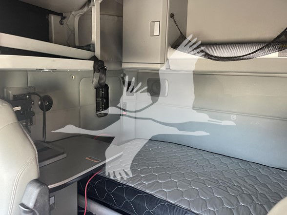 Kenworth T880 sleeper cab interior showing upper bunk area and mattress with quilted cover.