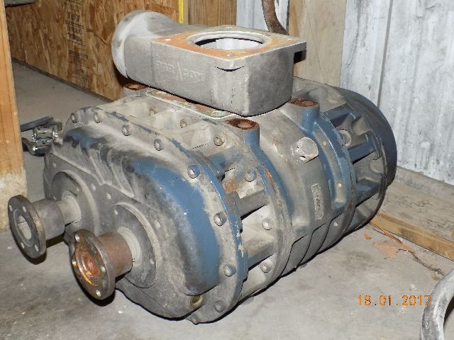 Paragon P857 blower and PTO attached to a blue industrial housing, mounted on a wooden crate in a workshop.