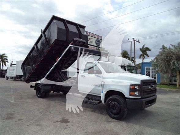 Chevrolet Silverado 6500HD dump truck with dump bed raised.