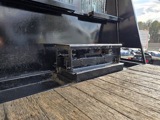 Peterbilt 348 rollback truck bed with a mounted tool/storage box on the wooden tailgate area.