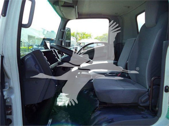 Isuzu NRR truck cab interior showing front seats and dashboard.