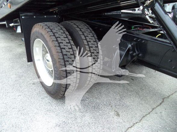 Dual rear wheels of a Freightliner M2 chassis showing heavy-duty tires and rear axle assembly.