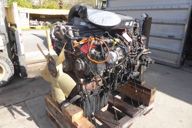Detroit DD13 engine core mounted on wooden pallet with wiring and components visible.