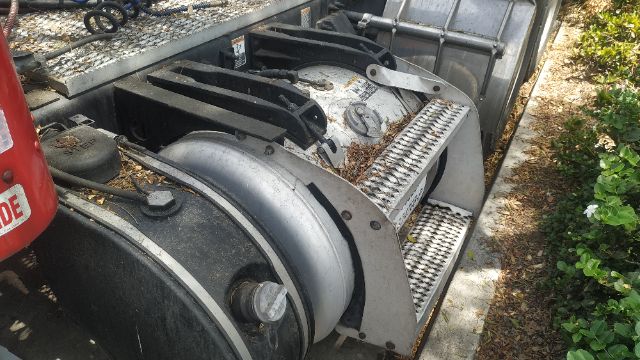 Truck cab and steps area with fuel tank mounting and ladder rungs visible.