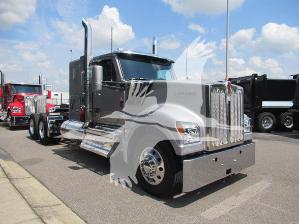 Kenworth W990 conventional sleeper truck showing chrome grille and side steps, front view