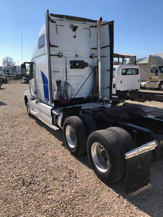 Volvo truck cab rear view showing fifth wheel area and exposed air lines and electrical cables.