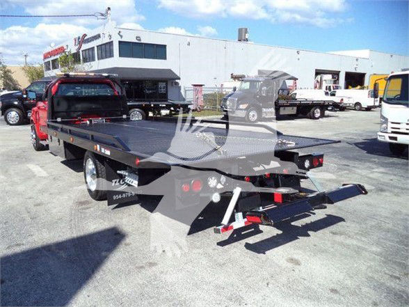 Tow truck flatbed with rear view showing flatbed bed and towing equipment.