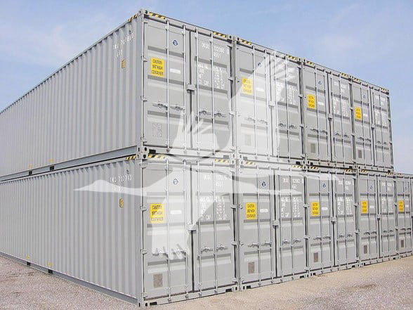 New 40' General purpose high cube shipping containers stacked two-high showing doors with yellow warning labels.
