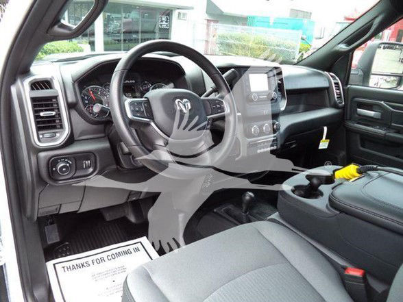 Ram 4500 interior cab showing steering wheel with Ram logo, center touchscreen, dashboard controls, and front seats.