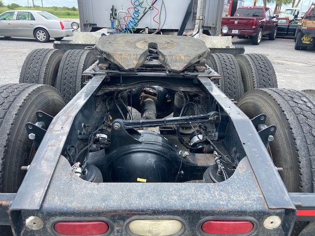Mack CXU613 chassis shown from rear with fifth wheel, dual rear axles, air and hydraulic lines, and chassis frame.