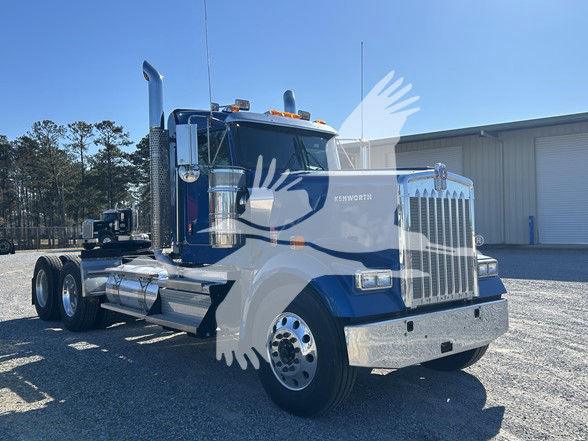 Kenworth W900L conventional daycab truck in blue and chrome with large chrome grille, dual rear axles, and chrome exhaust stacks.