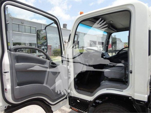 Isuzu NRR truck cab interior showing driver seat and open door with steps and side mirror
