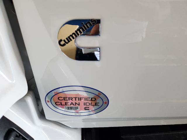 Cropped rear cab area of a 2025 Hino L6 with Cummins badge and a 'Certified Clean Idle' sticker visible on the door panel.