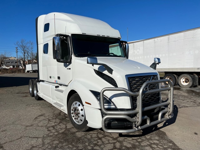 Volvo VNL760 conventional sleeper truck showing bull bar guard and side view, white exterior, daytime.