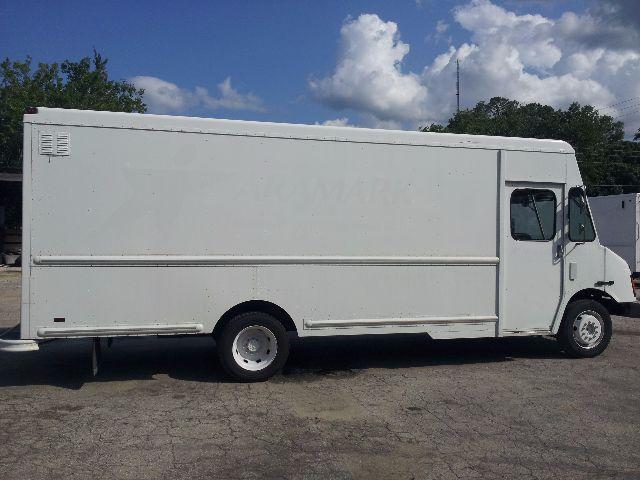 Workhorse P42 step van side view showing cargo body and cab door with wheel.