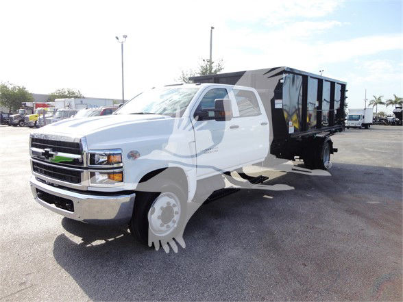 2023 Chevrolet SILVERADO 5500HD truck with a white cab and a dump bed, front three-quarter view.