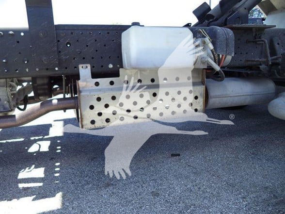 Underbody of truck showing diesel fuel tank and perforated metal guard