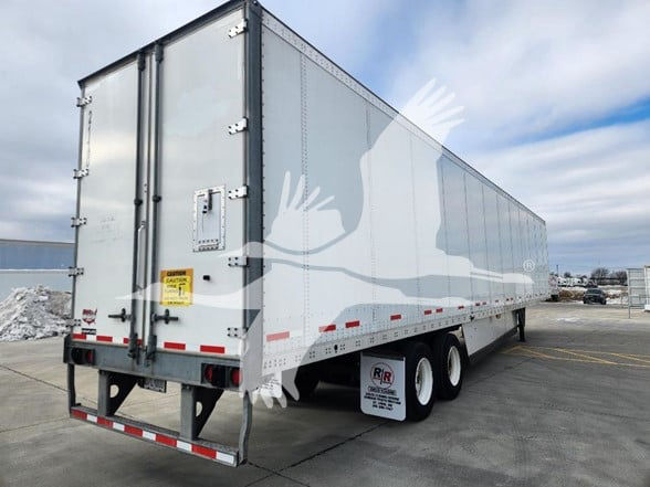 Trailer side and rear of a 2021 Wabash van trailer with grey exterior, dual rear doors, andWheel fenders visible.