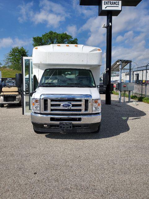 Ford E-450 shuttle bus front view with open driver door.