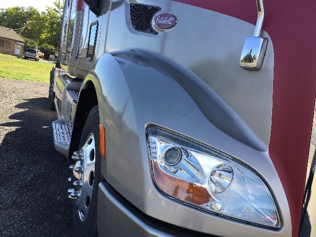 Peterbilt 578 cab front fender and headlight area showing gray paint and red accents.