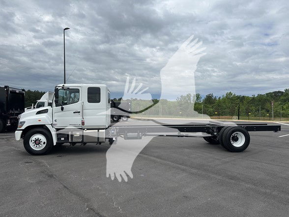 2026 Hino L6 cab and chassis with long flatbed, side view showing white cab and extended chassis