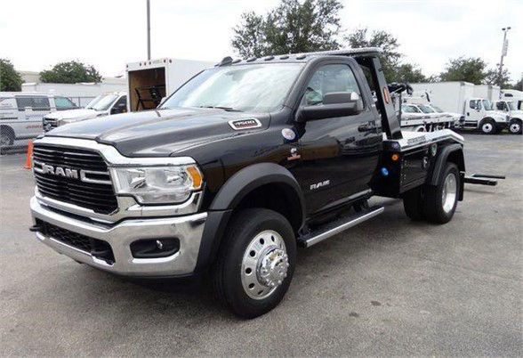 Ram 4500 tow truck in black with chrome front grille and dual rear wheels, Ram badge visible, flatbed/tow setup on long bed.