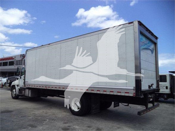 Truck trailer in a reefer fleet with a white abstract bird graphic on the side.
