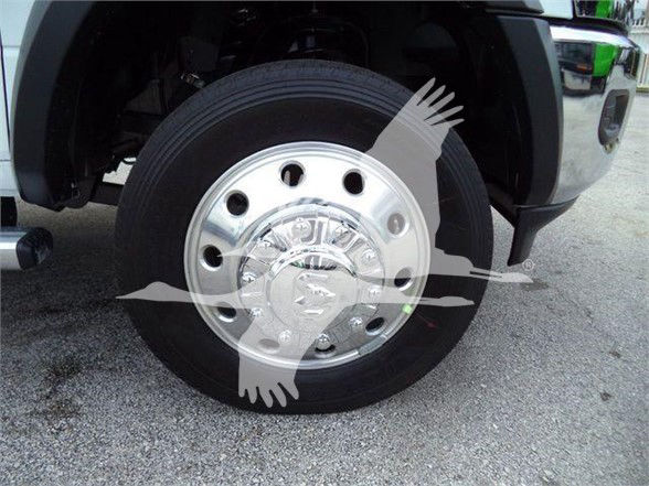 Ram 5500 SLT front wheel showing chrome hubcap and tire, partial fender, and vehicle. Text visible: none discernible on tire.