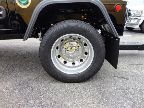 Ram 4500 SLT wheel and fender showing chrome wheel and tire in front of black body panel