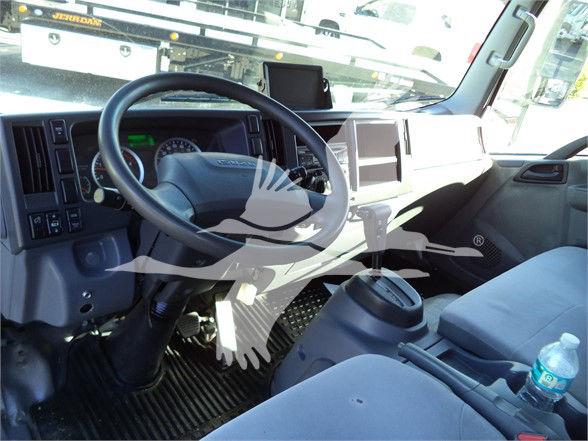 Isuzu NRR truck interior showing steering wheel and dashboard with digital display and center console.