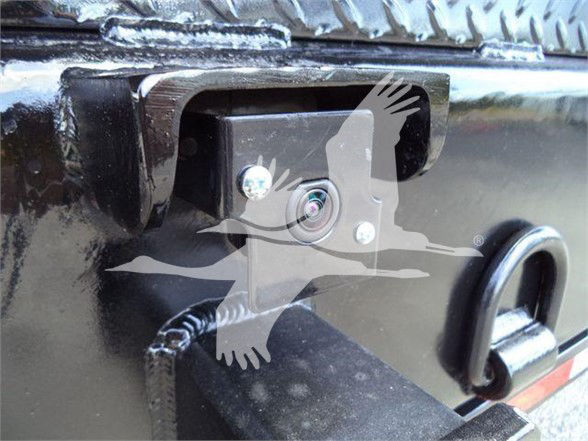 Back of a 2023 Chevrolet Silverado 6500HD with a backup camera installed in the tailgate area. Visible text includes nothing legible besides vehicle hardware.