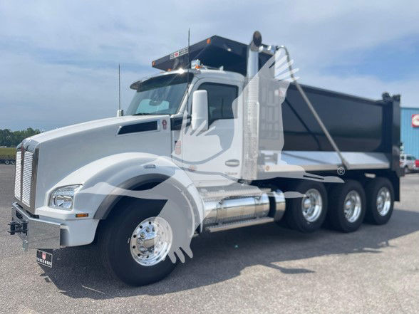 Kenworth T880 dump truck front-left view showing cab and dump bed with three rear axles.