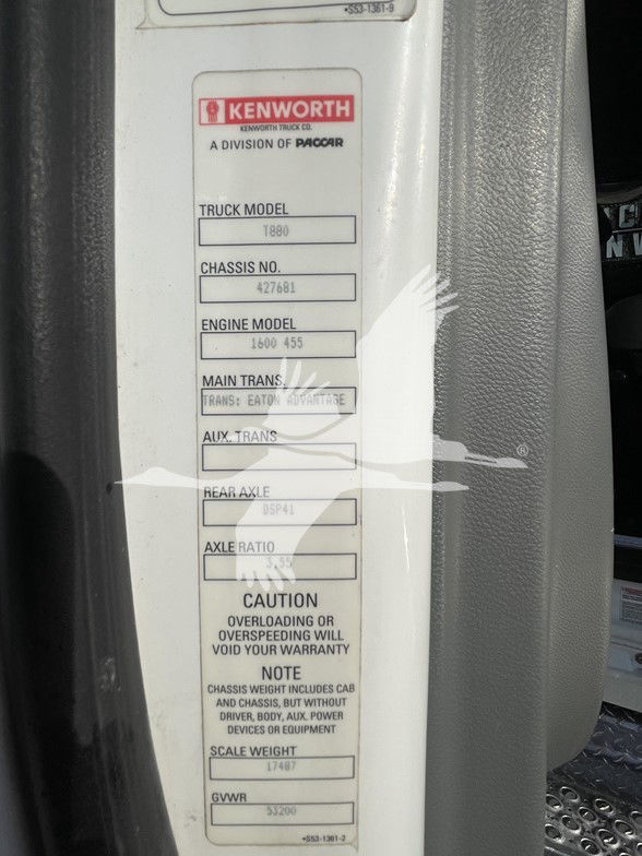 Kenworth badge on door jamb with labels: TRUCK MODEL T880, CHASSIS NO. 427681, ENGINE MODEL 1600 455, MAIN TRANS. (blank), NEAR AXLE (blank), AXLE RATIO (blank), CAUTION OVERLOADING OR OVERSPEEDING WILL VOID YOUR WARRANTY, NOTE CHASSIS
