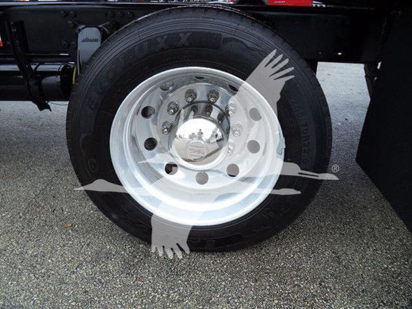 Wheel close-up showing a steel rim and tire on a Freightliner Business Class M2 106 truck.
